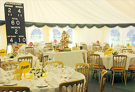 Cricket themed marquee with scoreboard dominating
