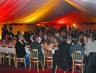 Party tent at night with red and yellow lighting