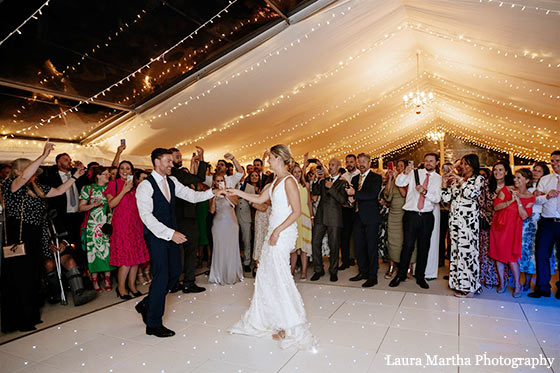 Bride and groom first dance in wedding marquee
