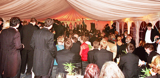 Watching a show in a large marquee Watching a show in a large marquee