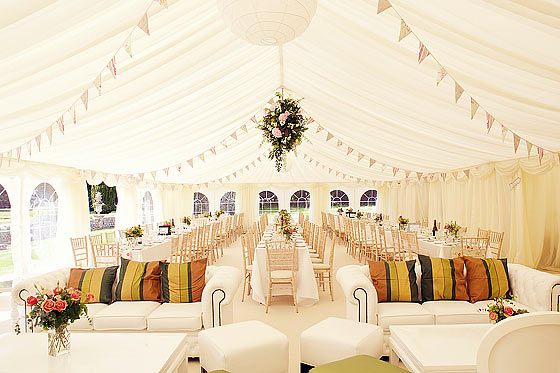 A simply decorated wedding marquee with bunting and table runners in Newport
