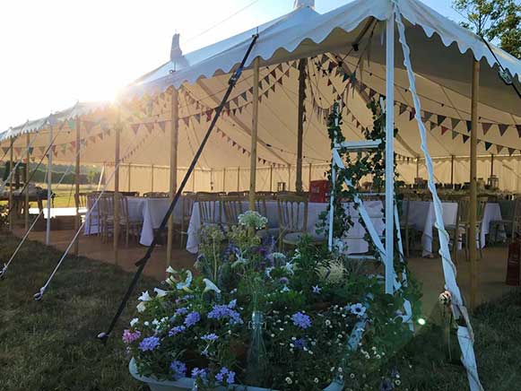 Traditional style wedding tent in a sheep field