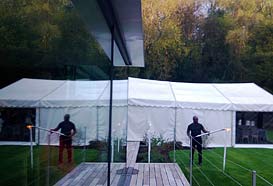 Party tent reflected in the glass house