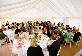 Wedding marquee with guests seated at tables