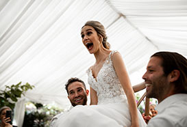 Bride carried on a chair