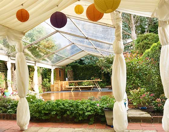 Marquee with clear roof panels and hanging lanterns