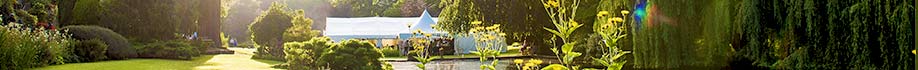 Large marquee nestling behind greenery